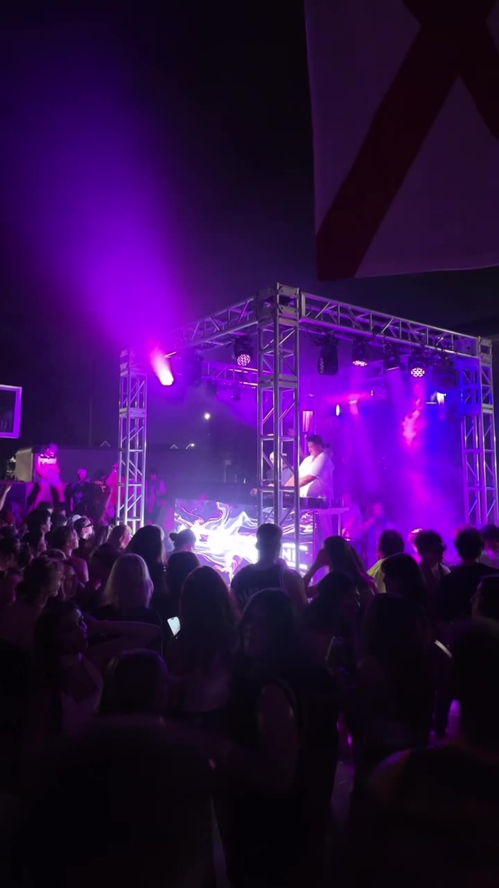Outdoor stage production with band performing