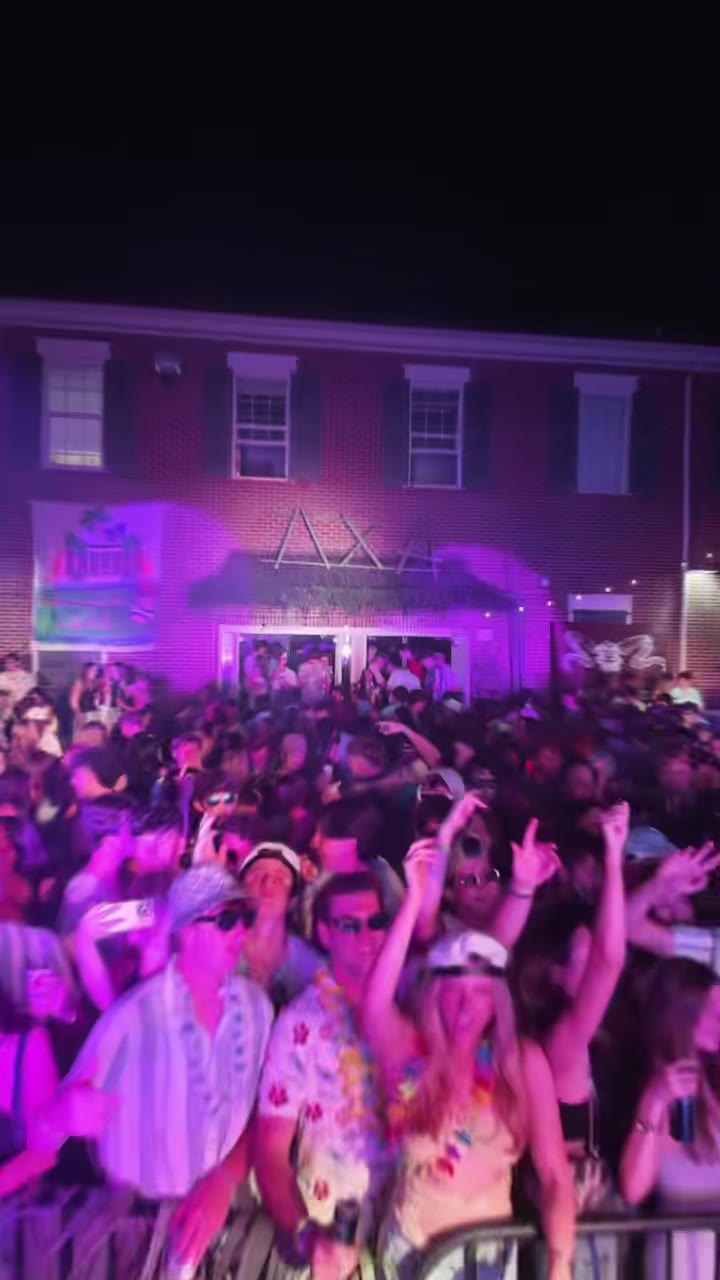 Festival mainstage with packed crowd at night, full lighting rig